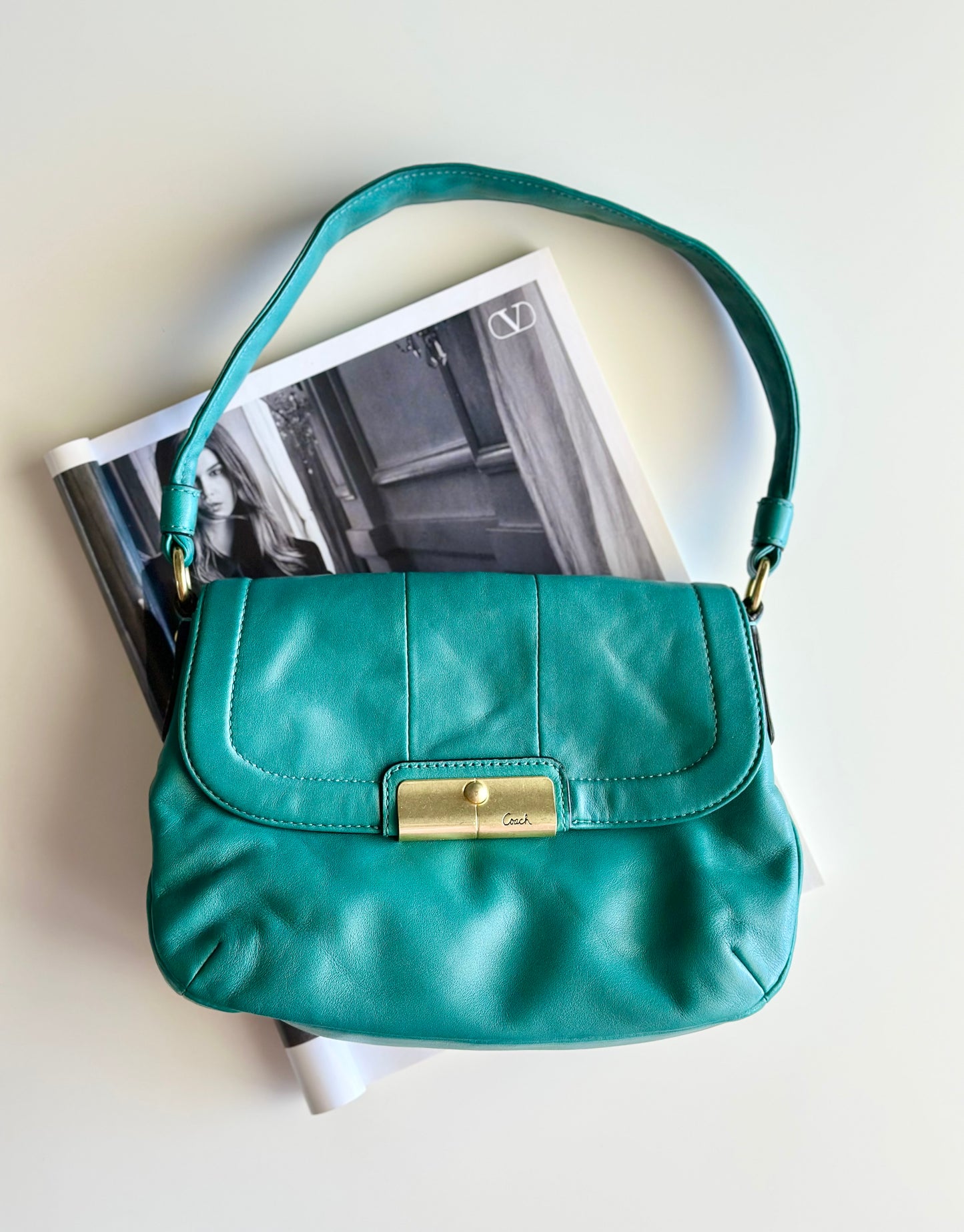 Vintage Coach leather bag in a striking turquoise-green