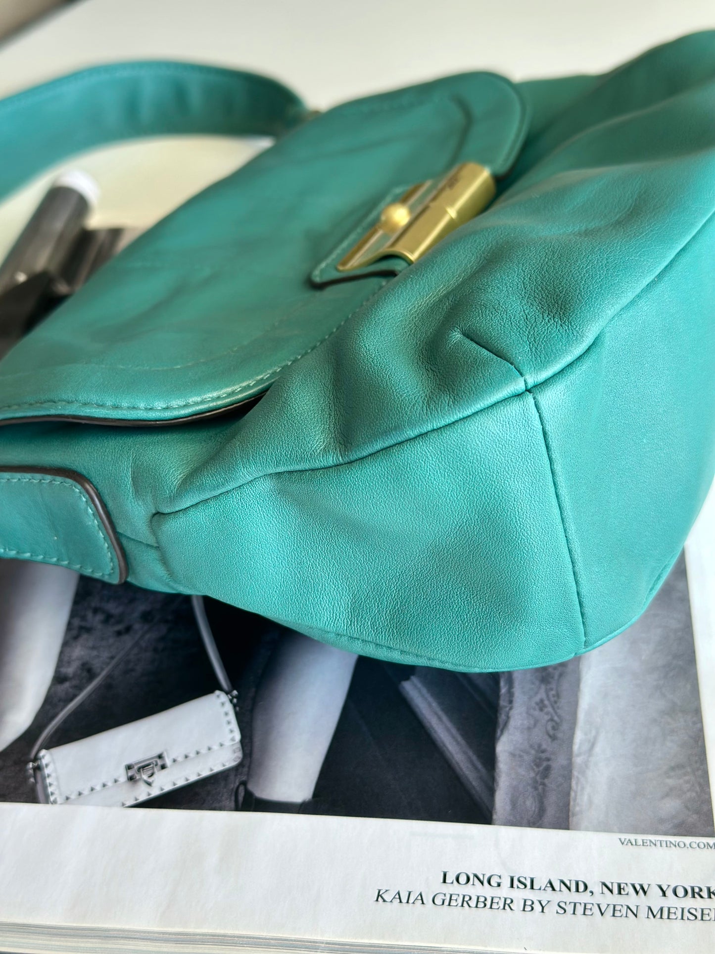 Vintage Coach leather bag in a striking turquoise-green