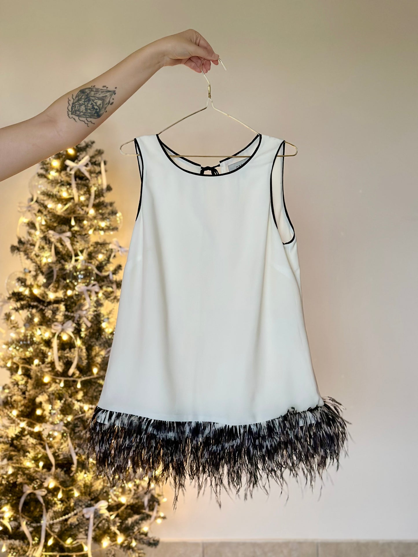 Lovely white tunic top with natural feathers