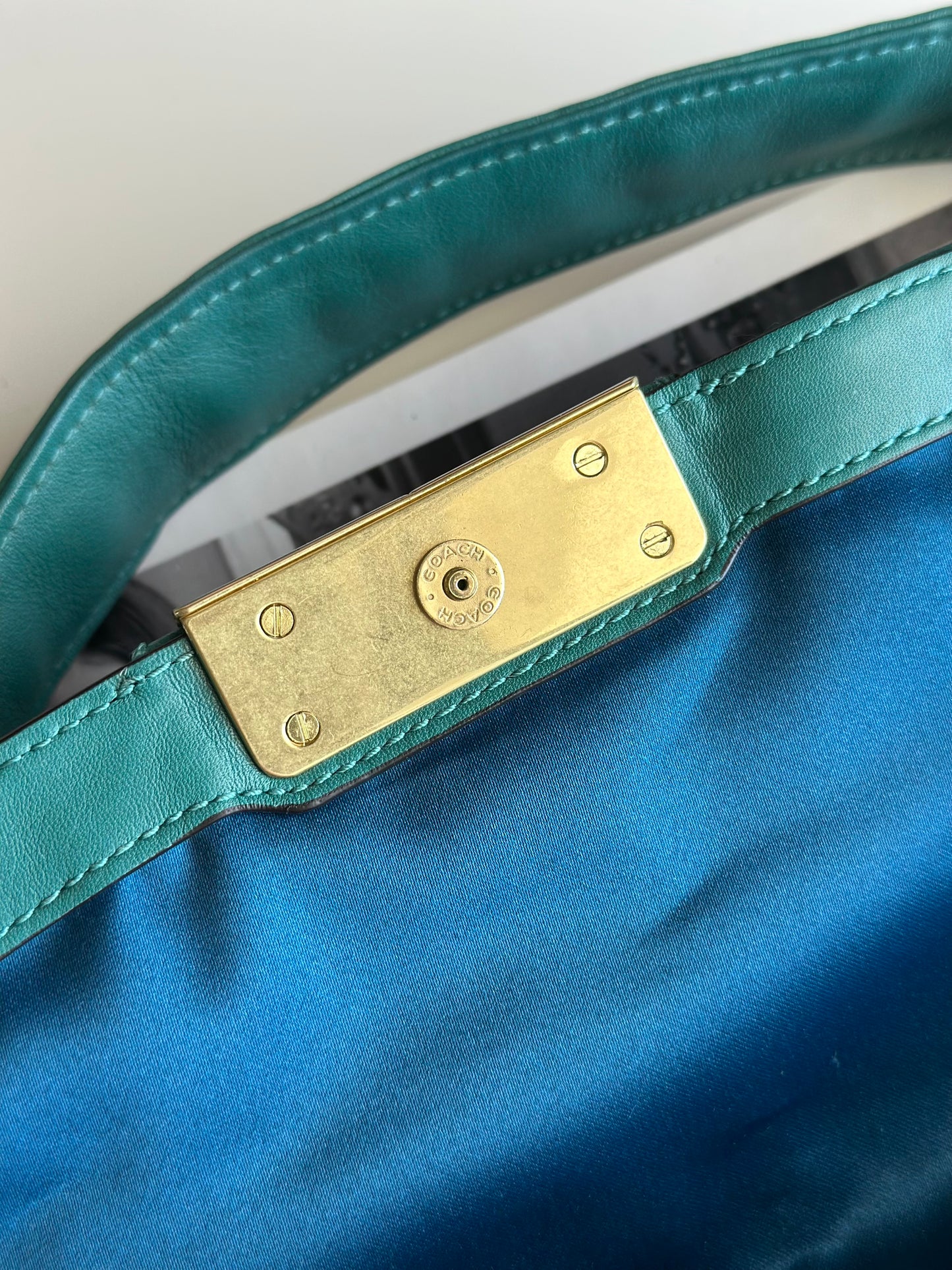 Vintage Coach leather bag in a striking turquoise-green