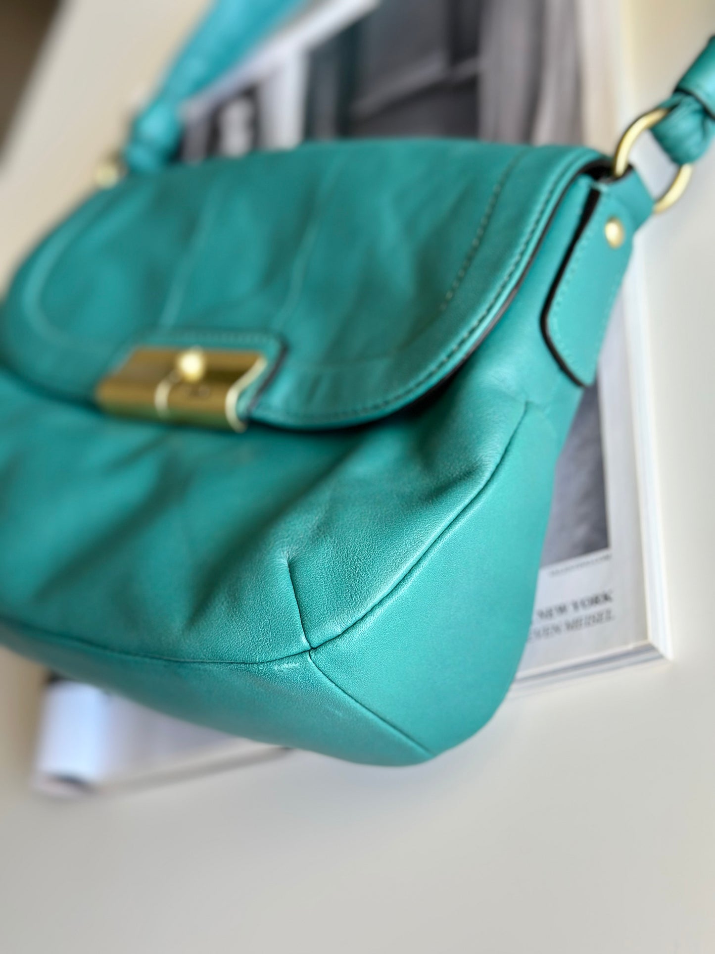 Vintage Coach leather bag in a striking turquoise-green