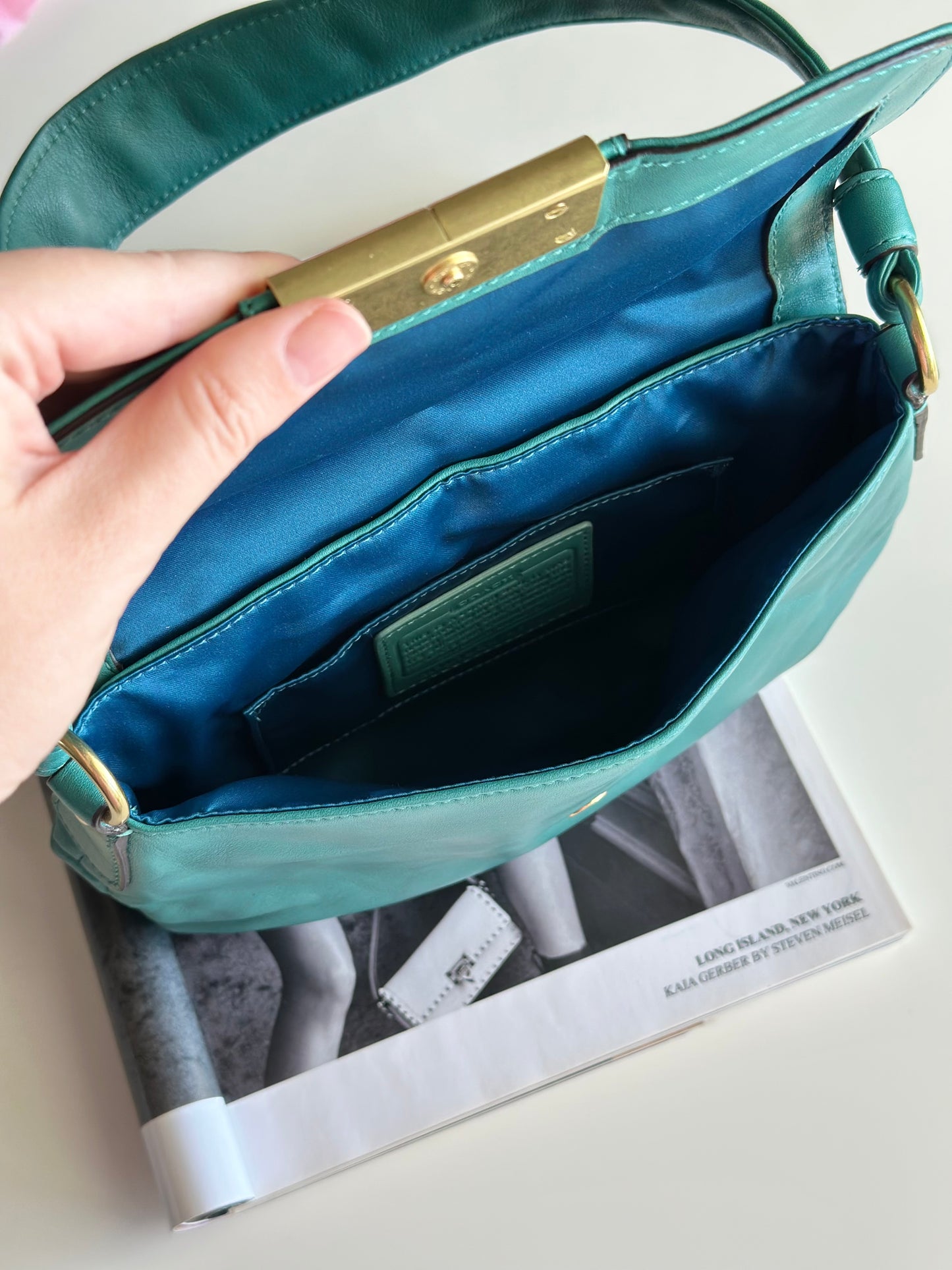 Vintage Coach leather bag in a striking turquoise-green