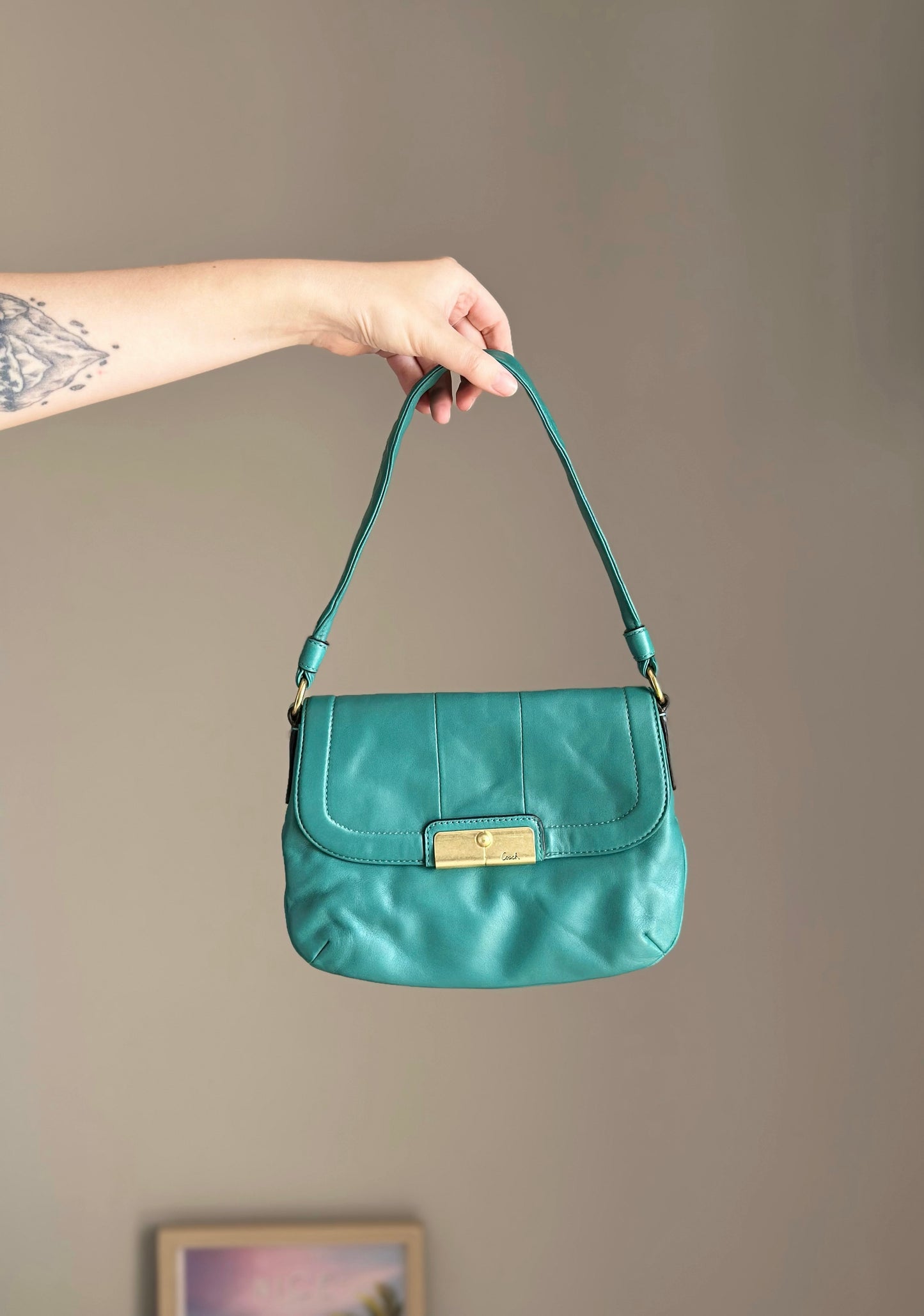 Vintage Coach leather bag in a striking turquoise-green