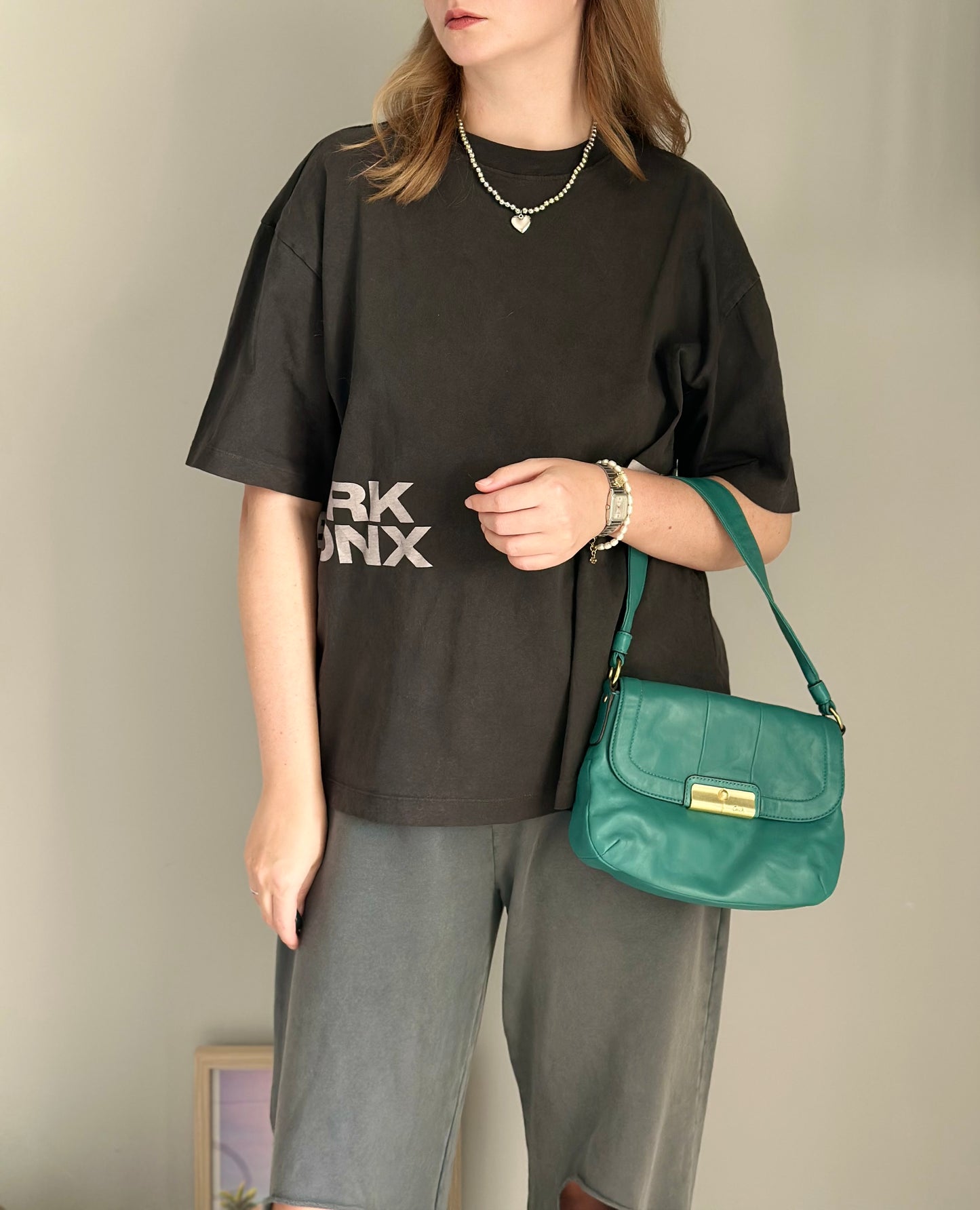 Vintage Coach leather bag in a striking turquoise-green