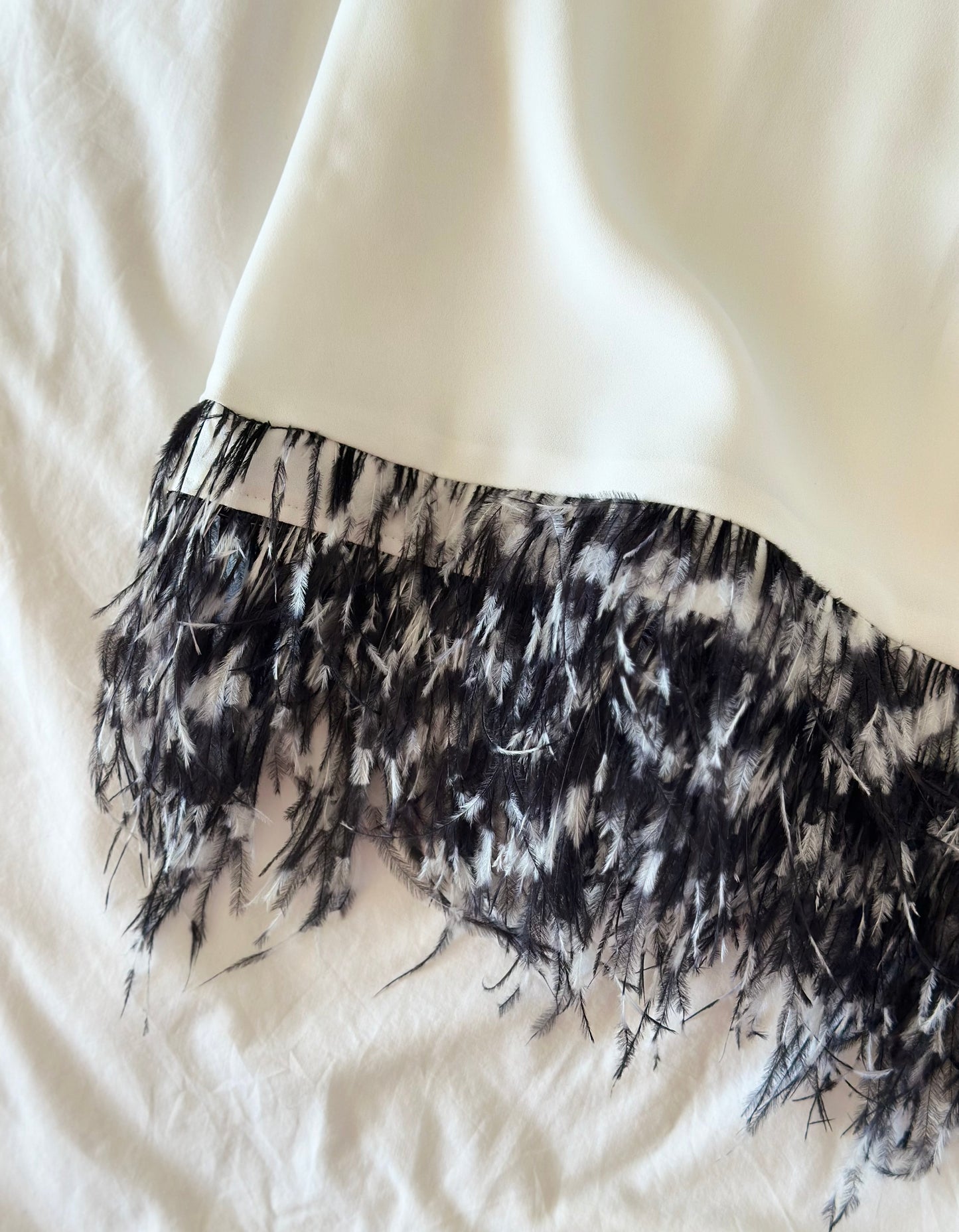 Lovely white tunic top with natural feathers