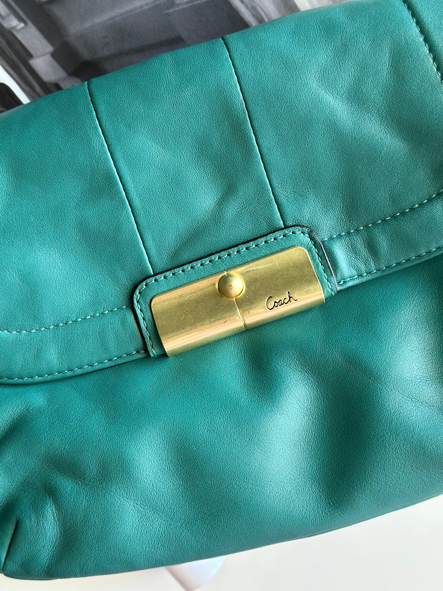 Vintage Coach leather bag in a striking turquoise-green