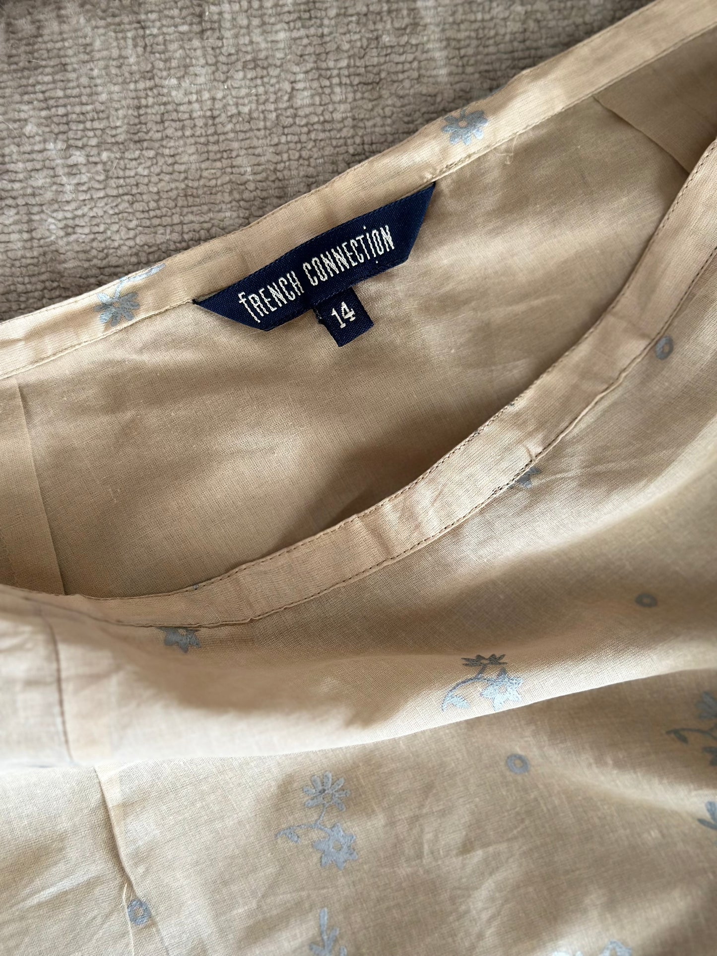 Soft beige cotton mini skirt with floral pattern