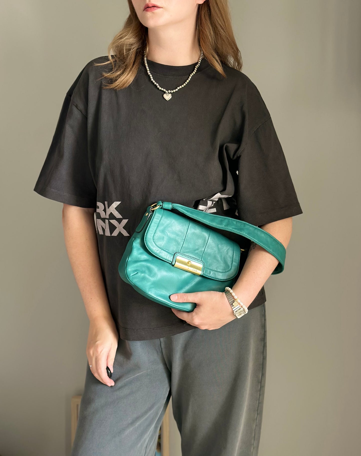 Vintage Coach leather bag in a striking turquoise-green