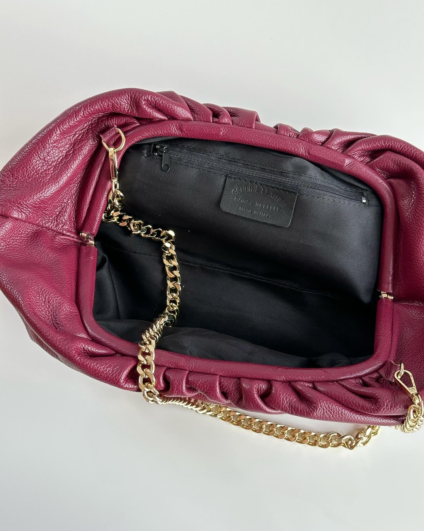 Amazing leather clutch bag in a burgundy color