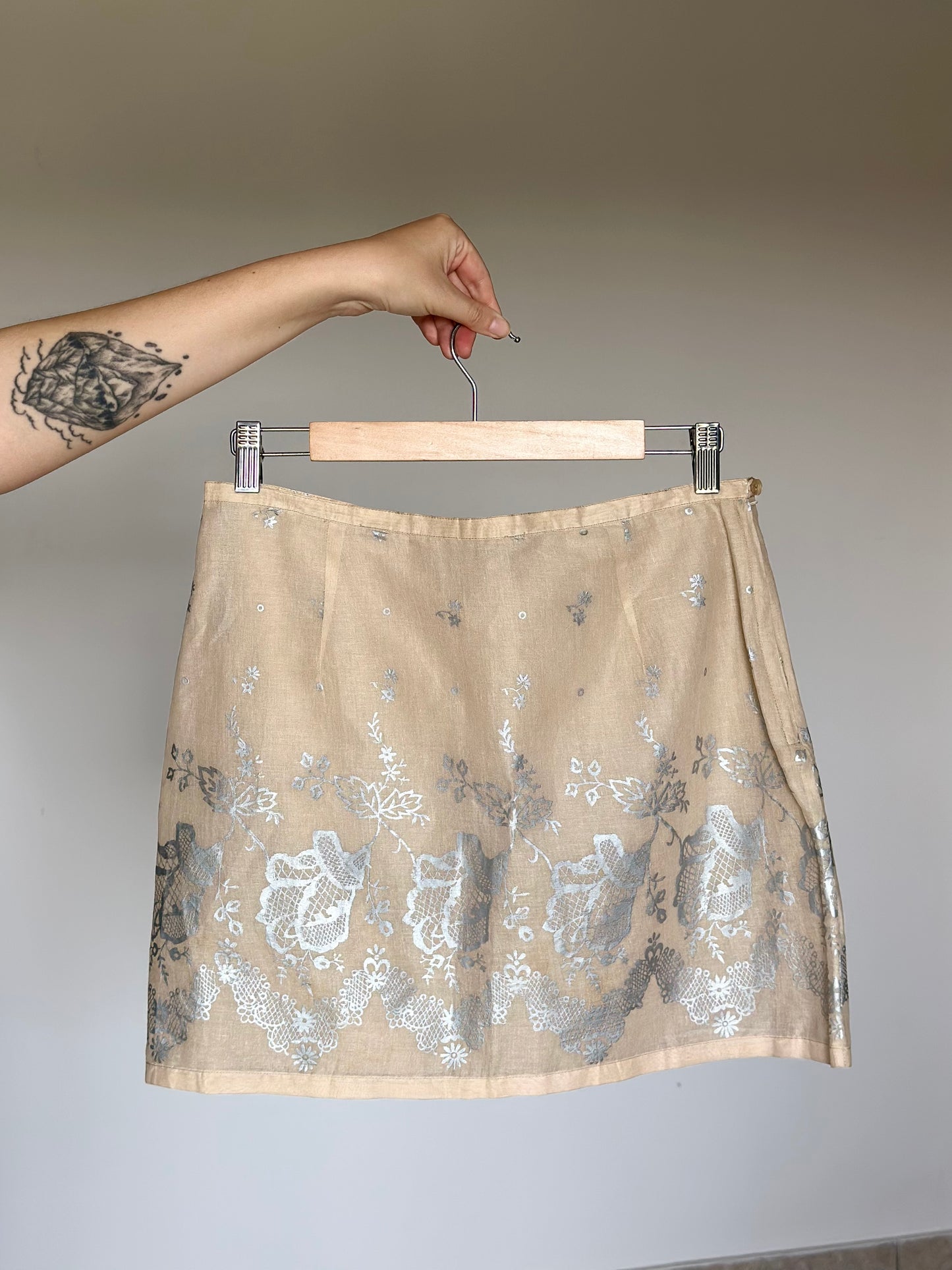 Soft beige cotton mini skirt with floral pattern