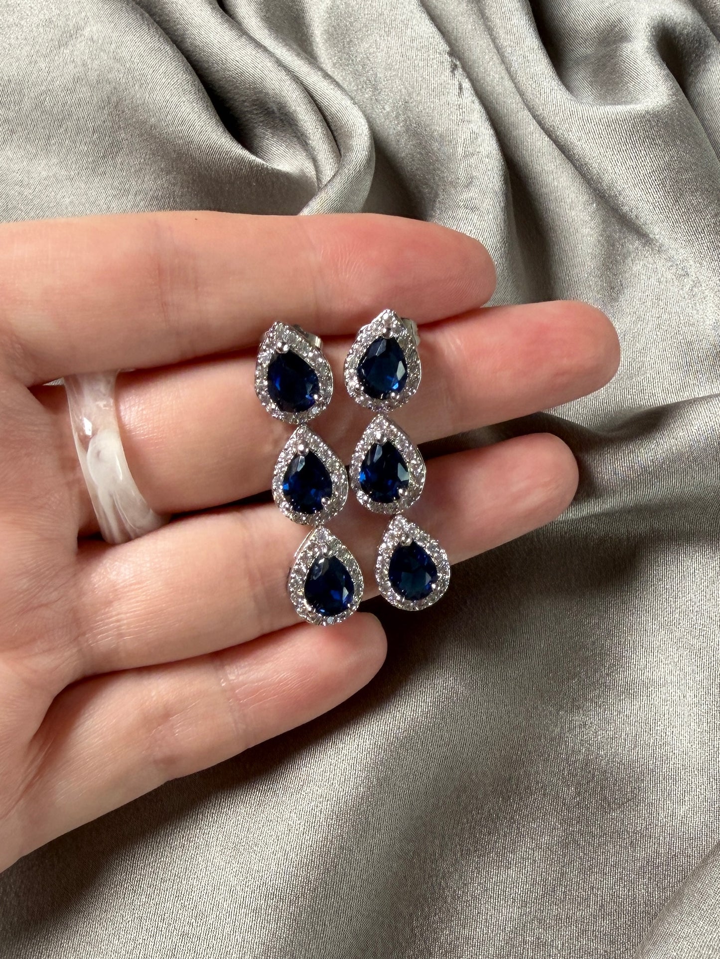 Exquisite earrings featuring a cascade of deep blue stones