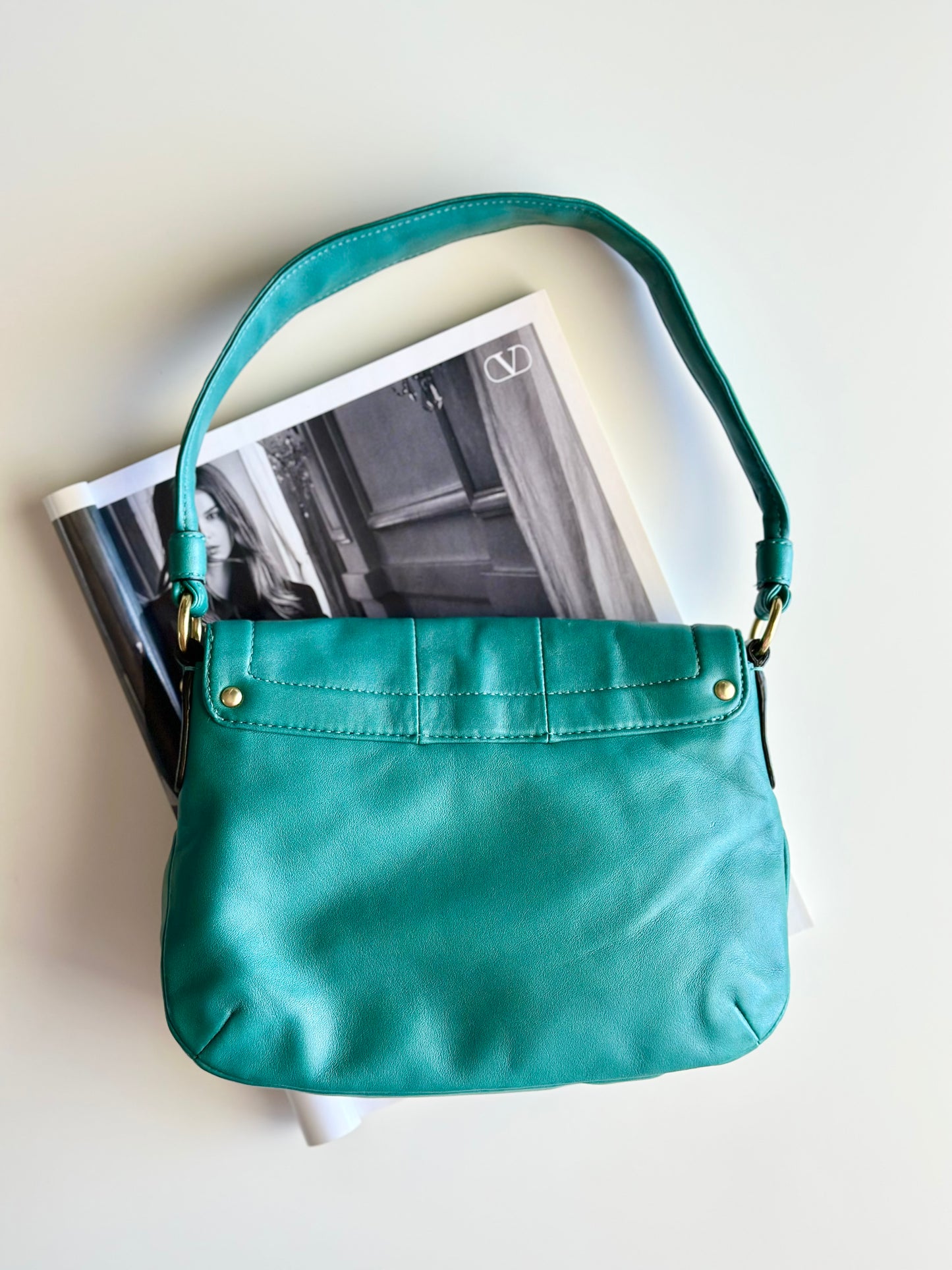 Vintage Coach leather bag in a striking turquoise-green