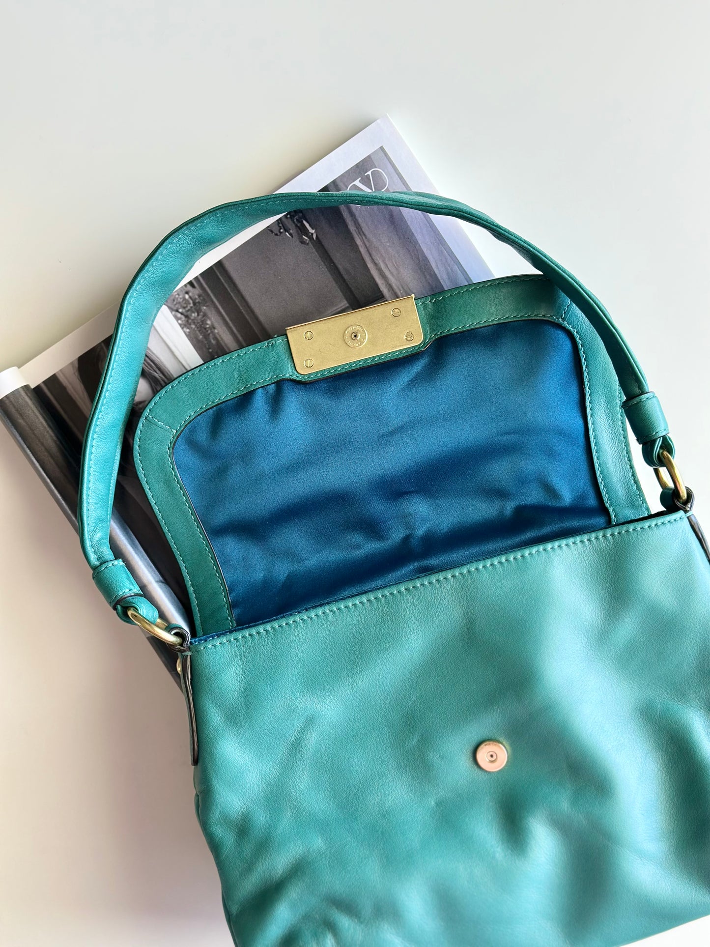 Vintage Coach leather bag in a striking turquoise-green