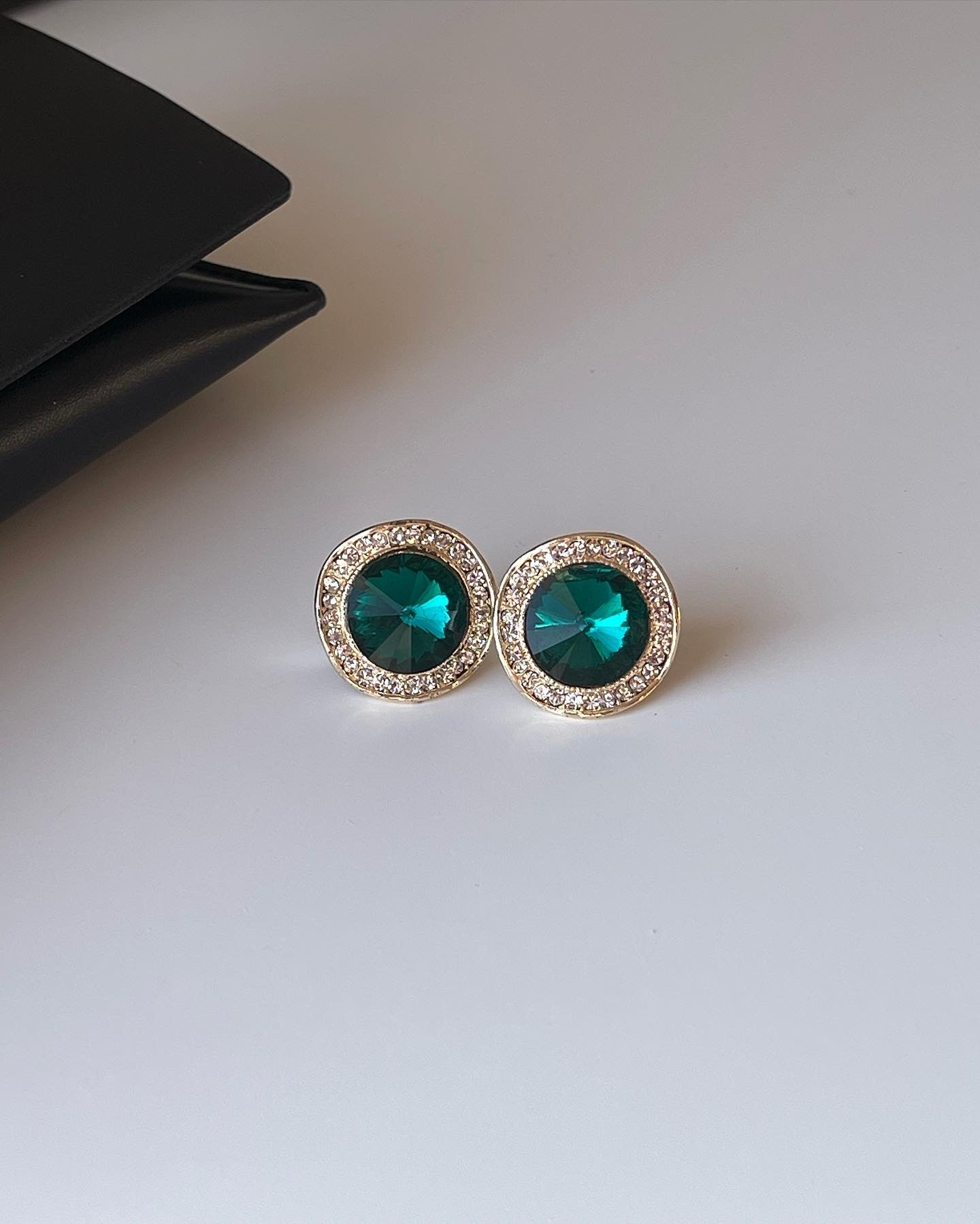 Vintage earrings decorated with green crystals and rhinestones