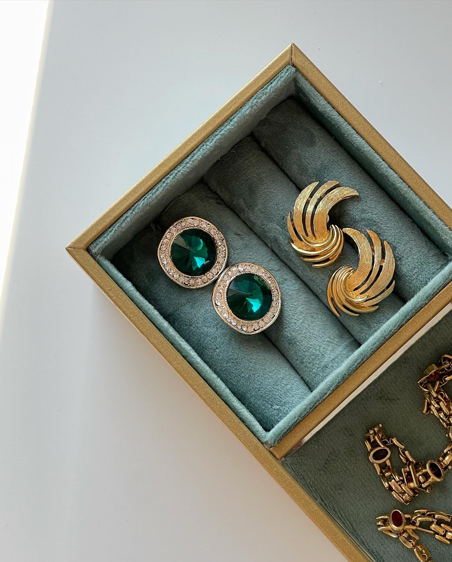 Vintage earrings decorated with green crystals and rhinestones