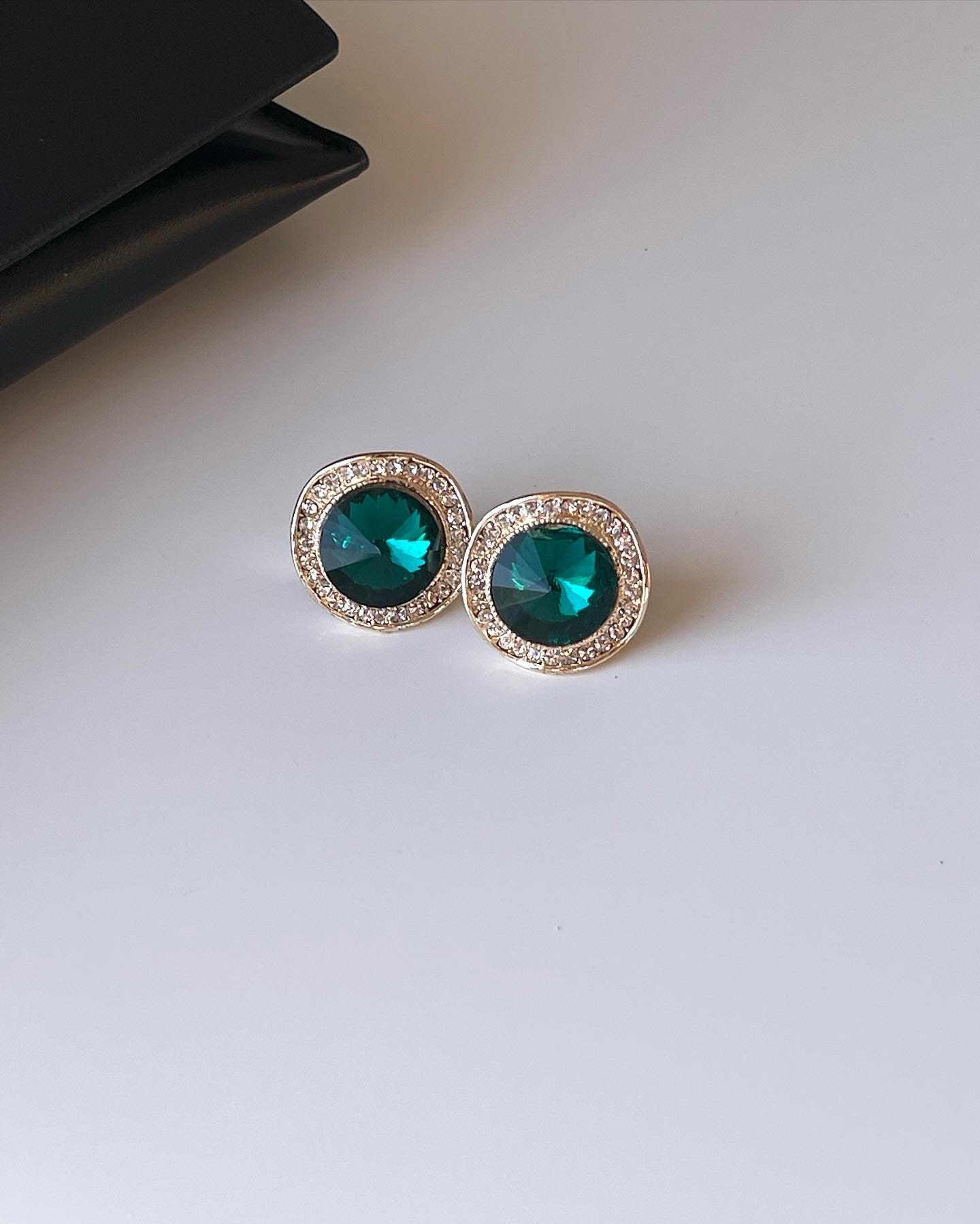 Vintage earrings decorated with green crystals and rhinestones