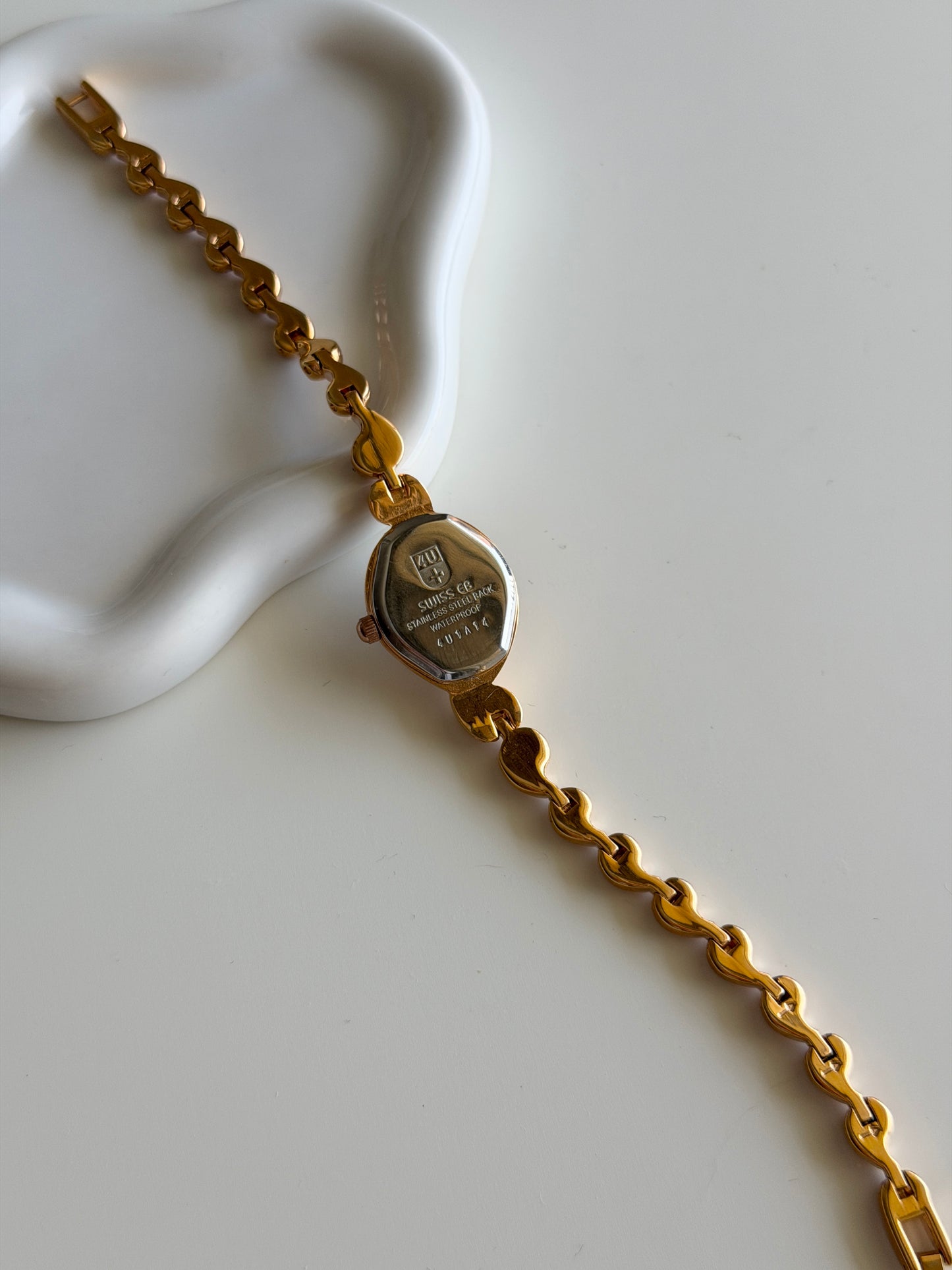 Vintage gold-tone watch with a striking black dial