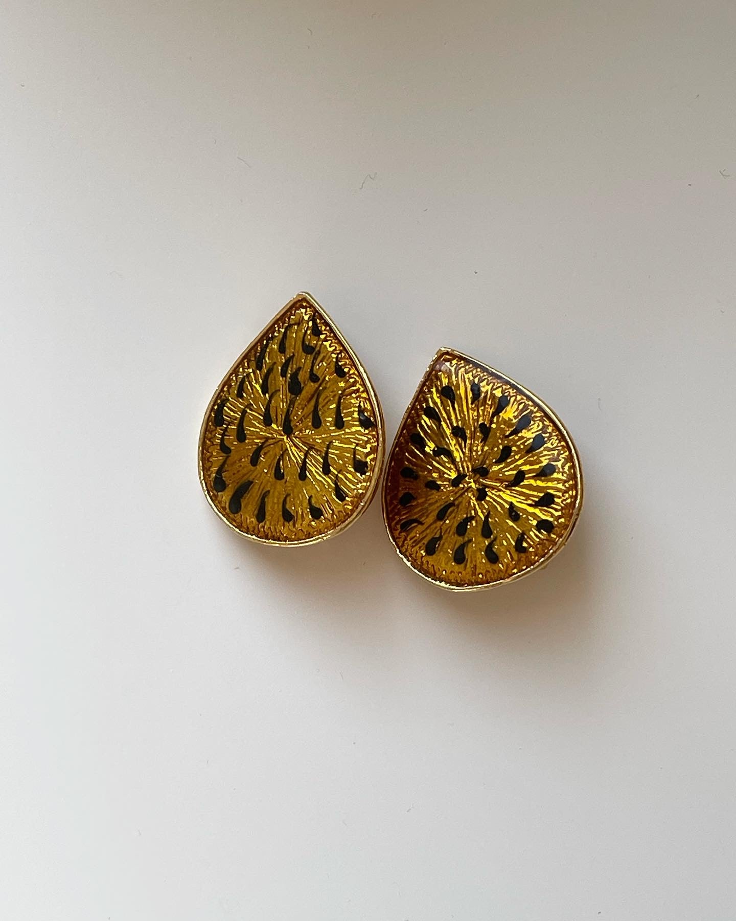 One-of-a-kind vintage enamel clip-on earrings in a beautiful gold/black tone