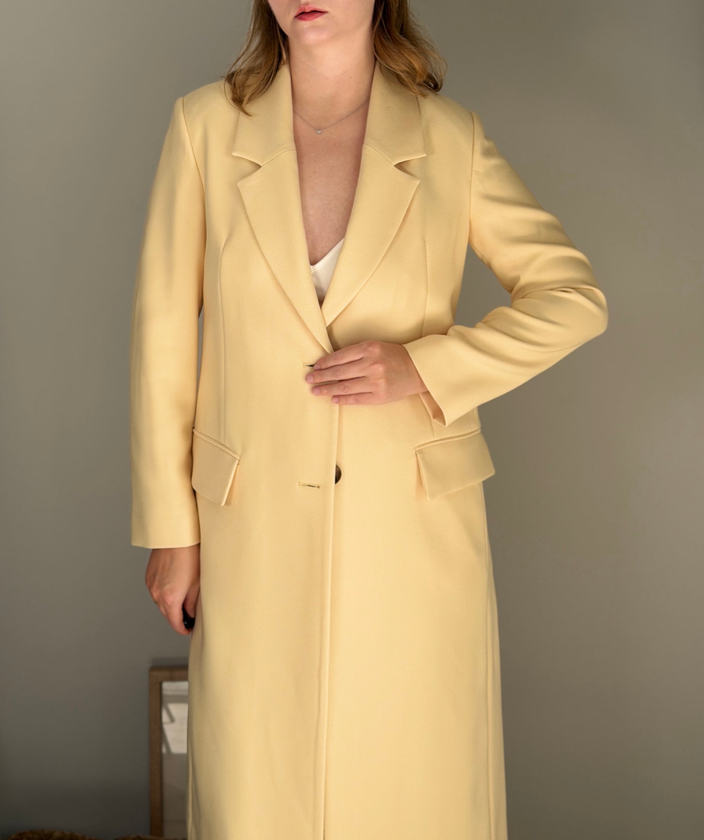 Stylish pale yellow long trench coat
