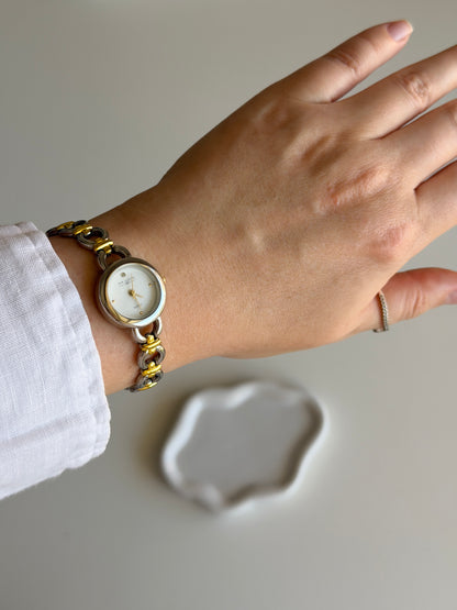 Vintage two-tone watch with a delicate round dial