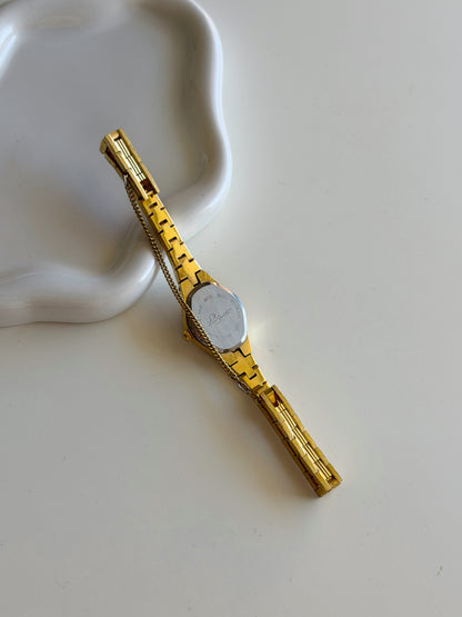 Vintage gold-tone watch with black heart dial