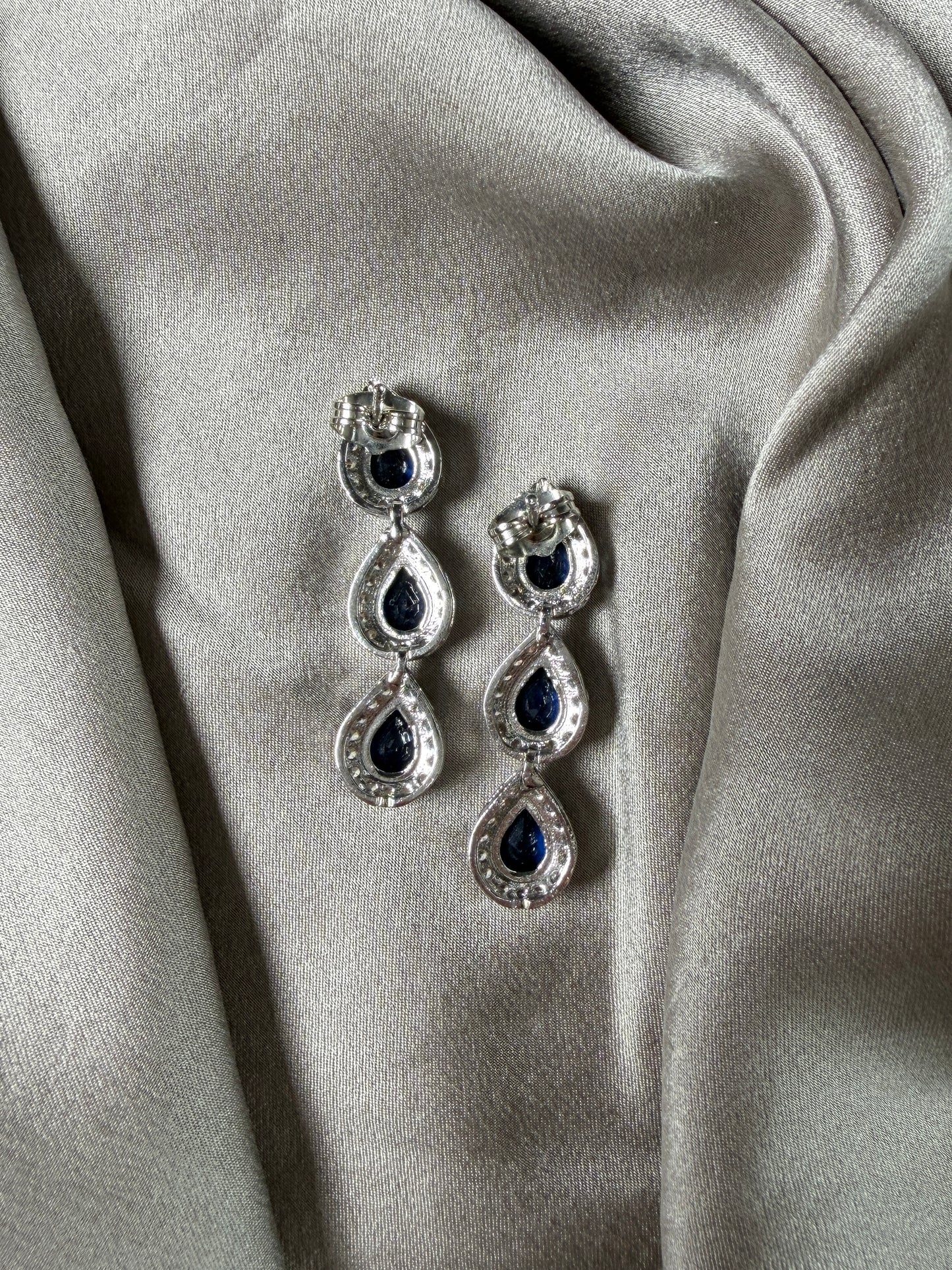 Exquisite earrings featuring a cascade of deep blue stones