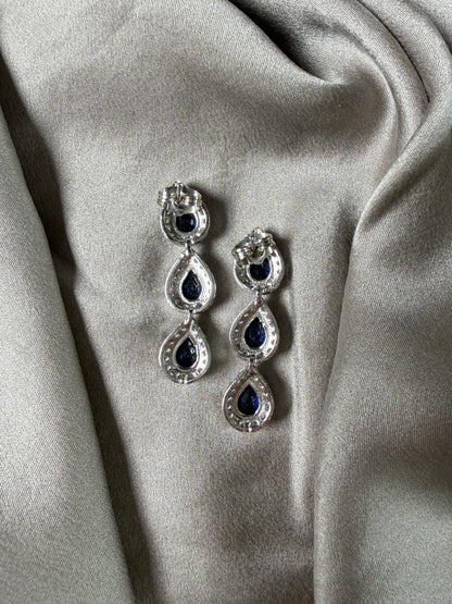 Exquisite earrings featuring a cascade of deep blue stones