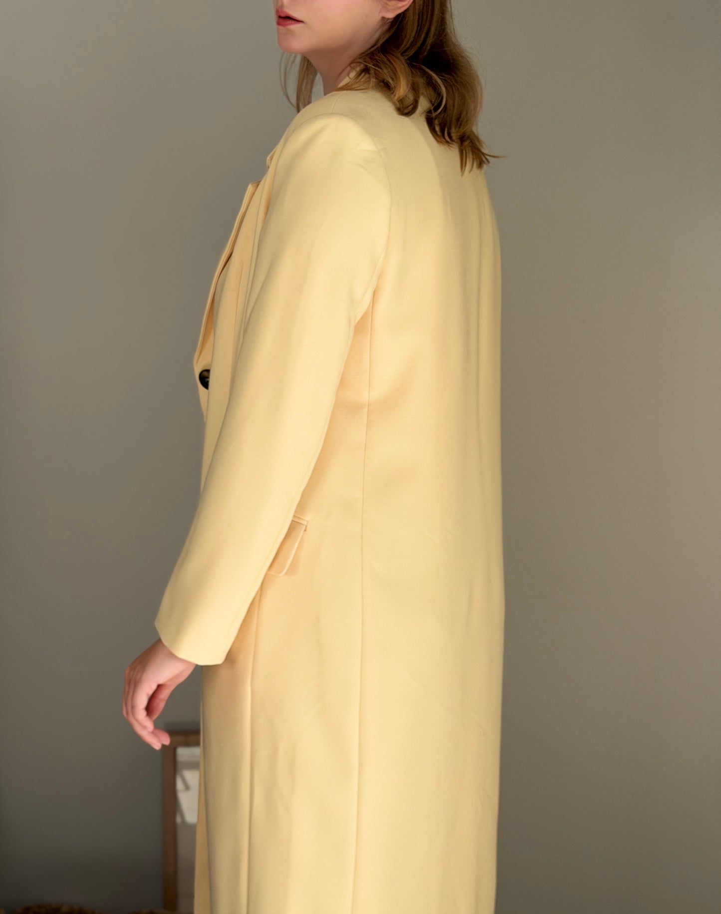 Stylish pale yellow long trench coat