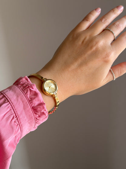 Beautiful gold-tone watch with feminine design