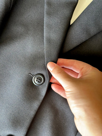 Striking vintage black blazer with open back