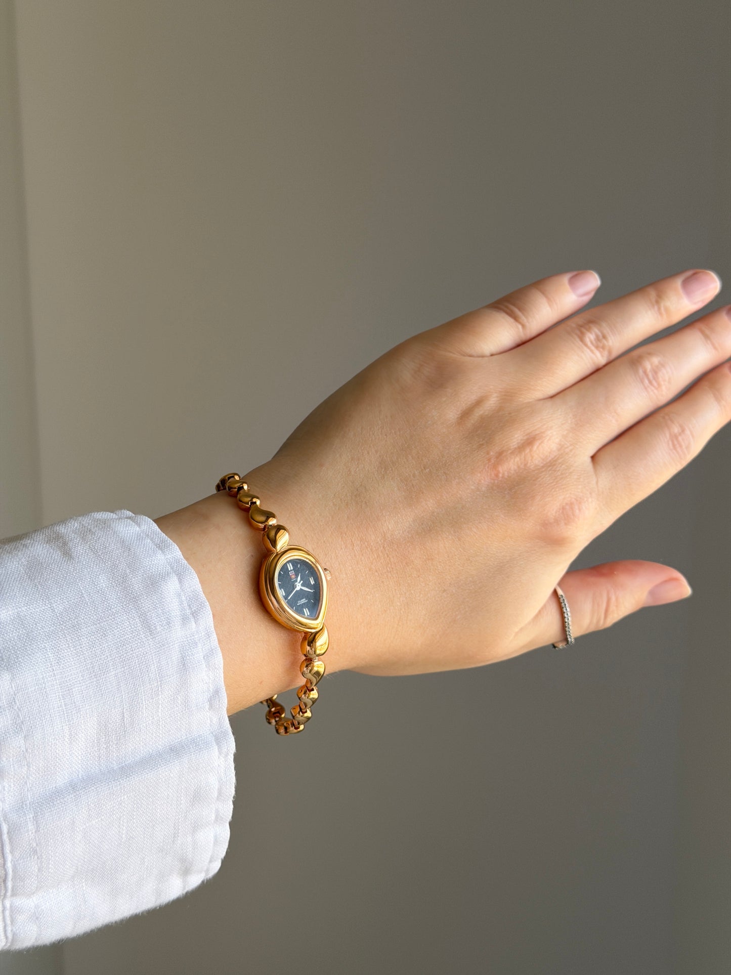 Vintage gold-tone watch with a striking black dial