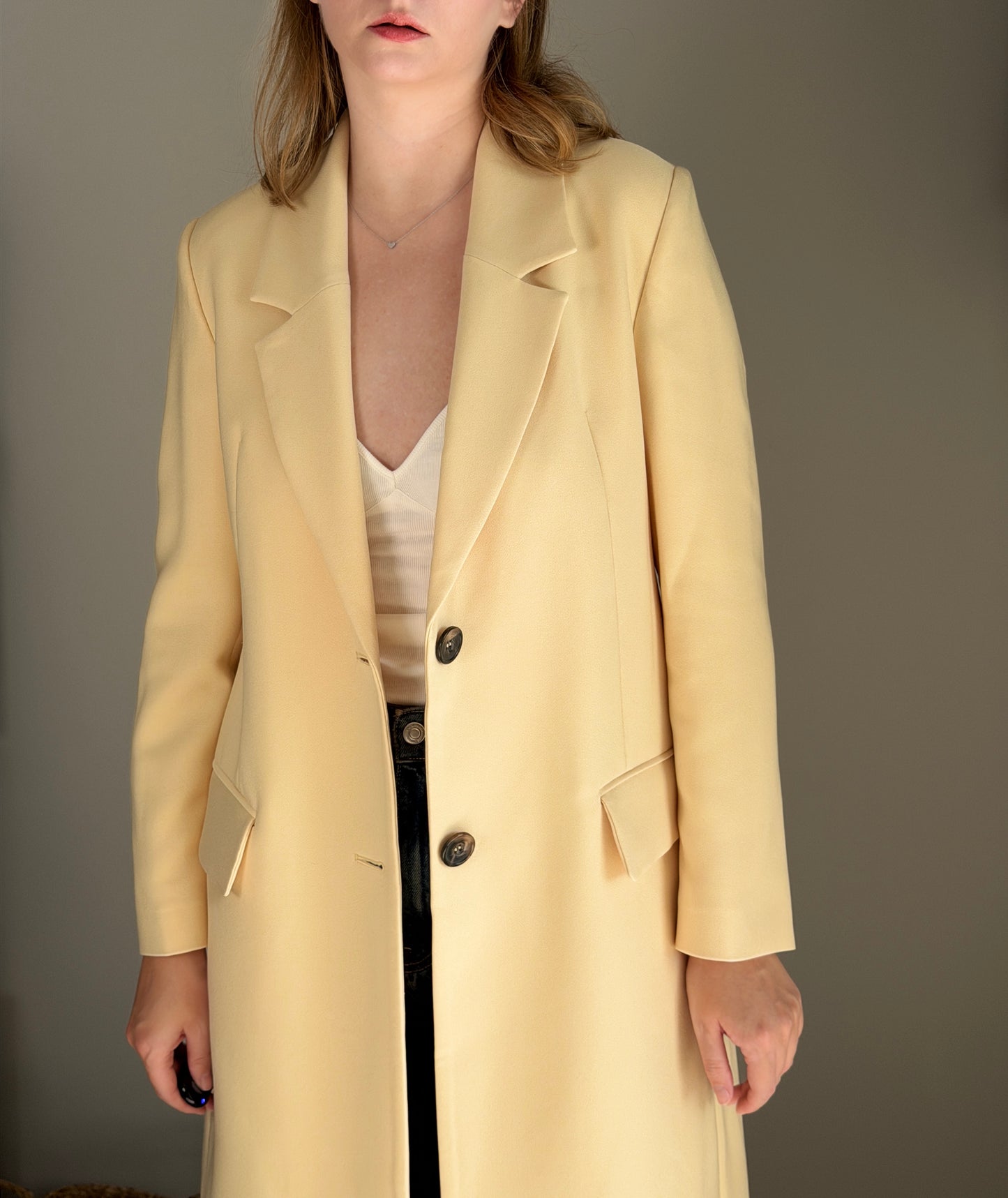 Stylish pale yellow long trench coat