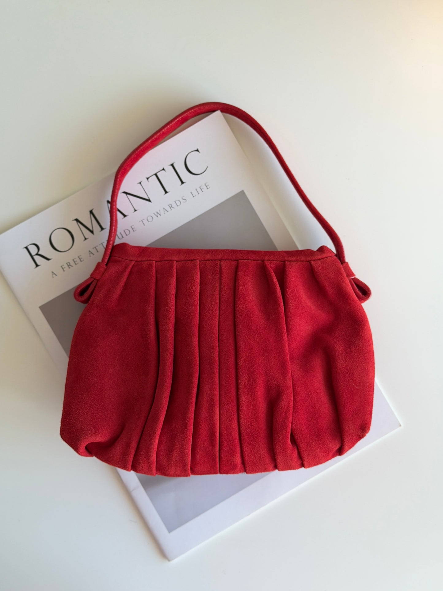 Vibrant red bag crafted from soft suede by Hobbs