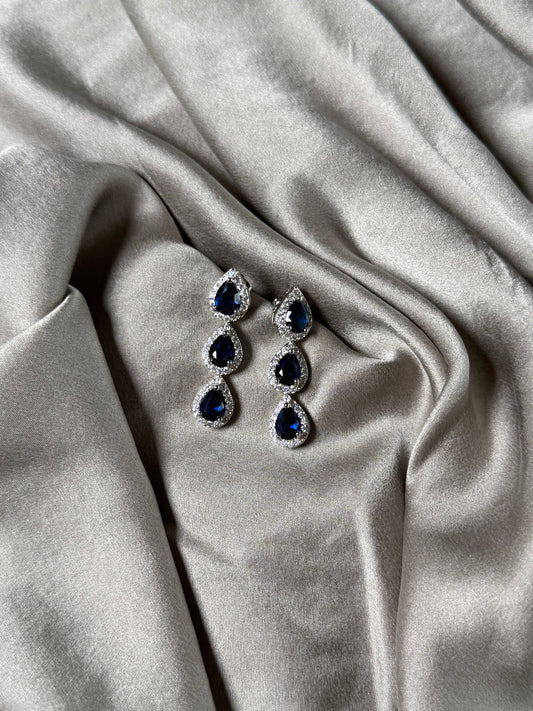 Exquisite earrings featuring a cascade of deep blue stones