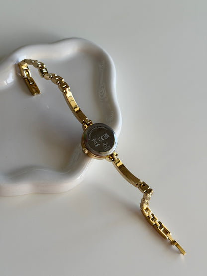 Beautiful gold-tone watch with feminine design