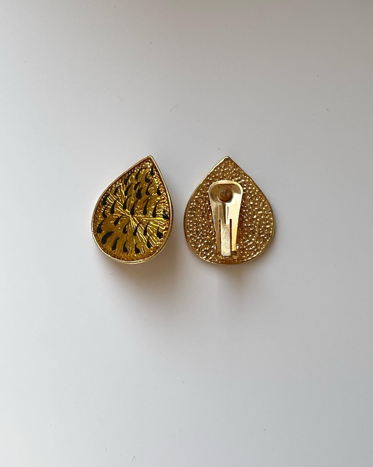 One-of-a-kind vintage enamel clip-on earrings in a beautiful gold/black tone