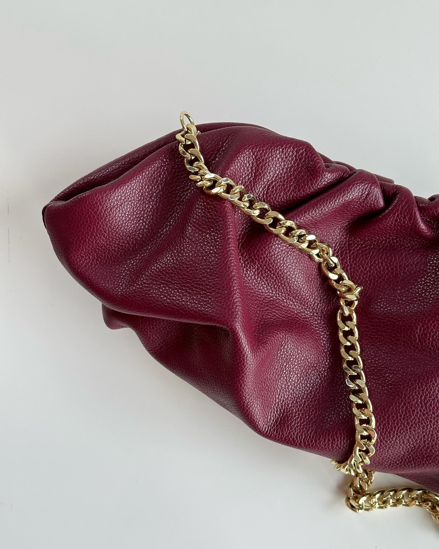Amazing leather clutch bag in a burgundy color