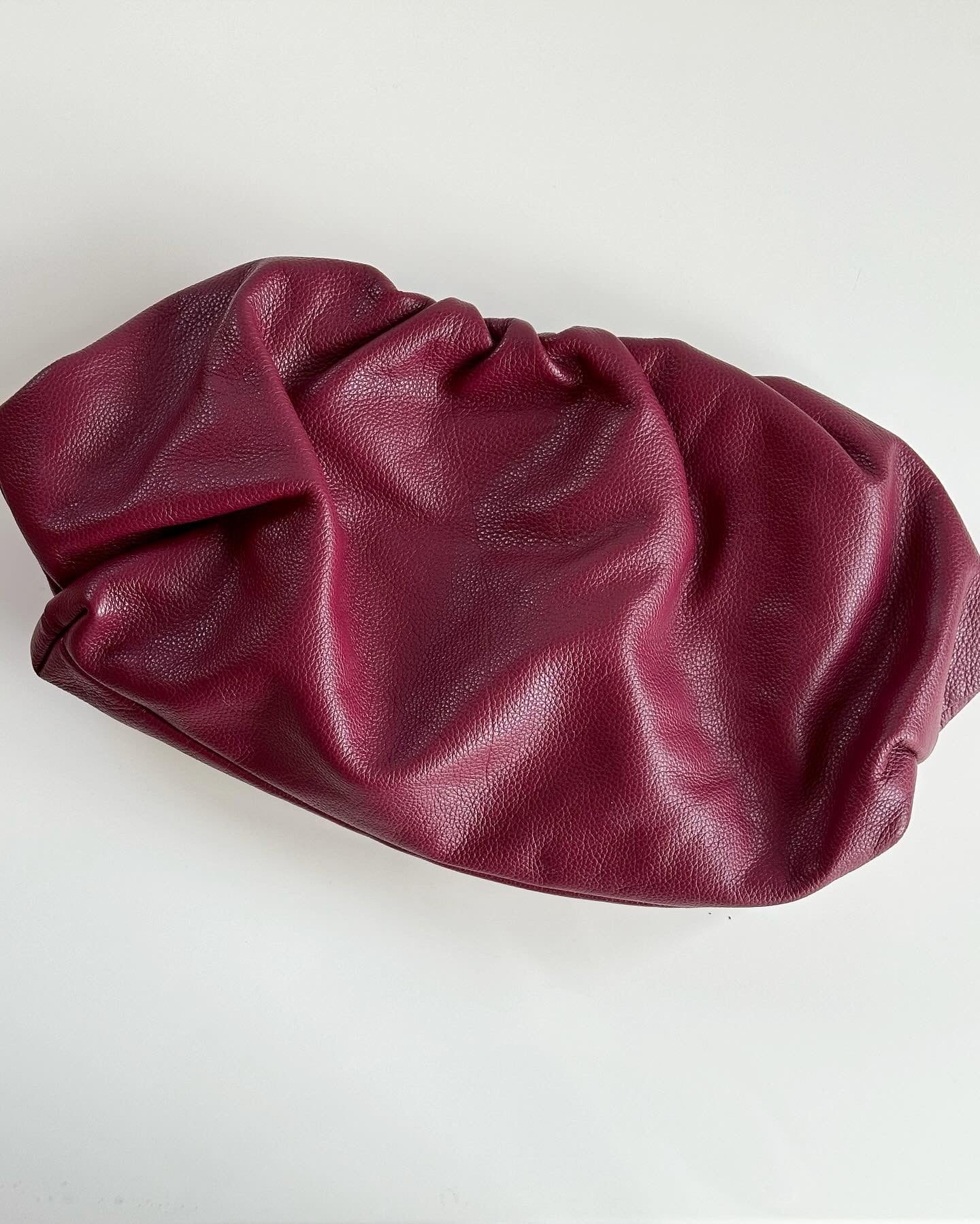 Amazing leather clutch bag in a burgundy color