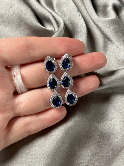 Exquisite earrings featuring a cascade of deep blue stones