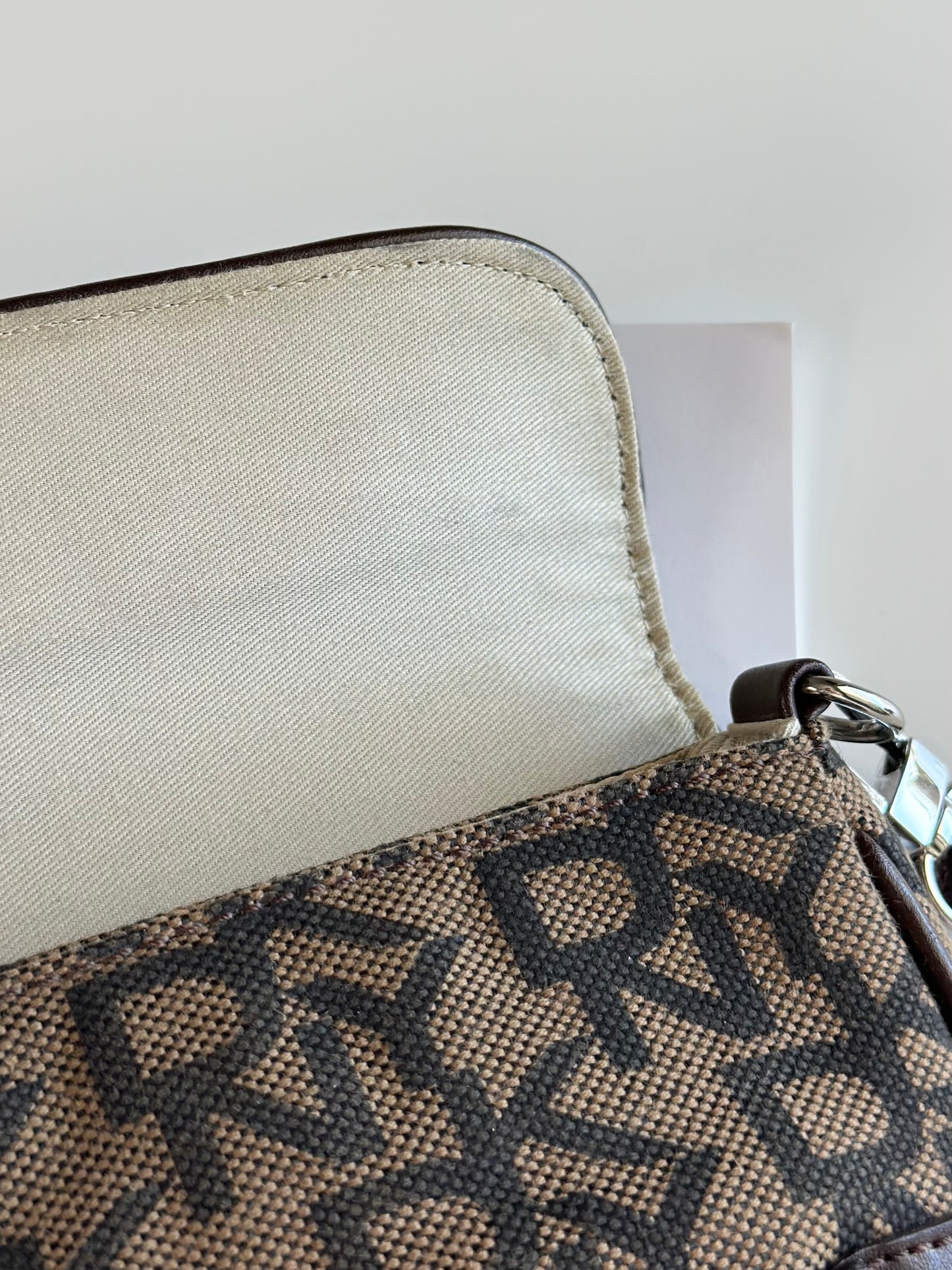 Chic vintage DKNY baguette bag with a rich brown monogram pattern