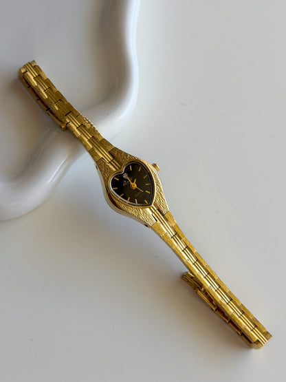 Vintage gold-tone watch with black heart dial