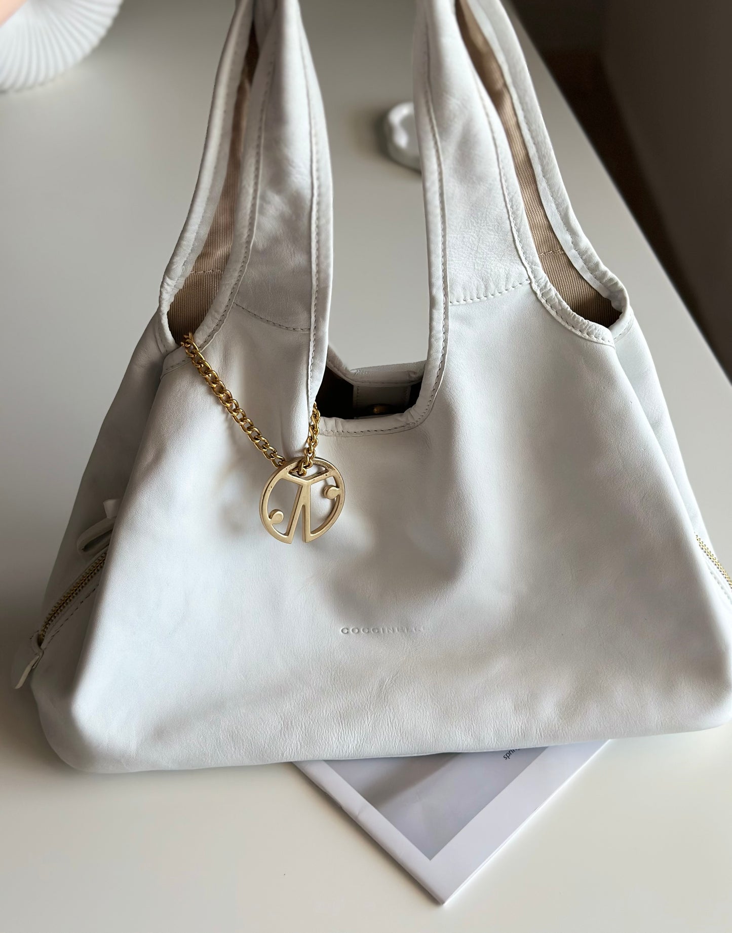 Stylish Coccinelle bag in soft white leather