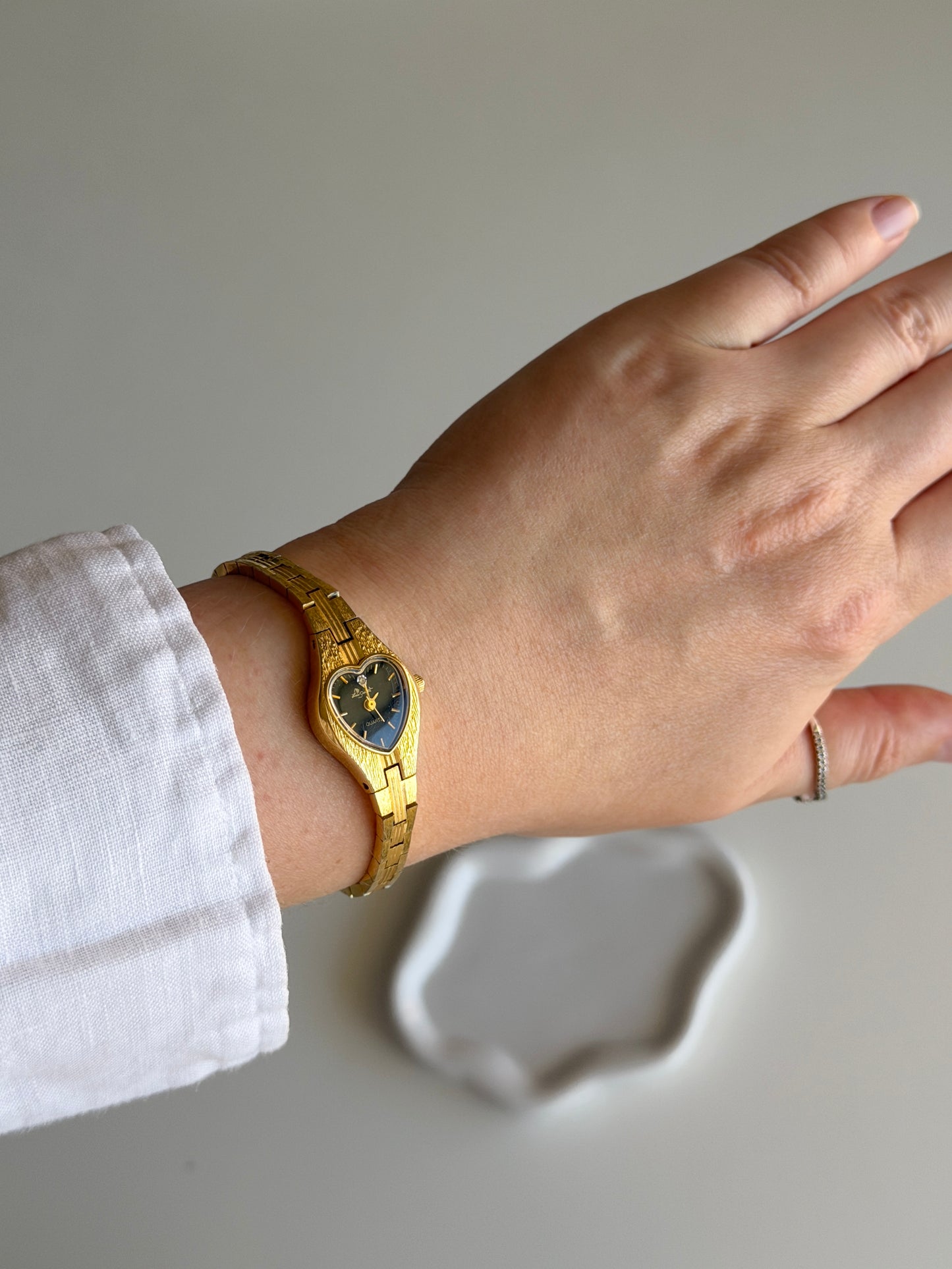 Vintage gold-tone watch with black heart dial