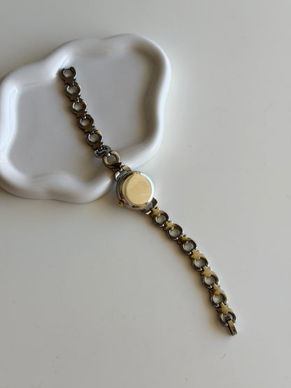 Vintage two-tone watch with a delicate round dial