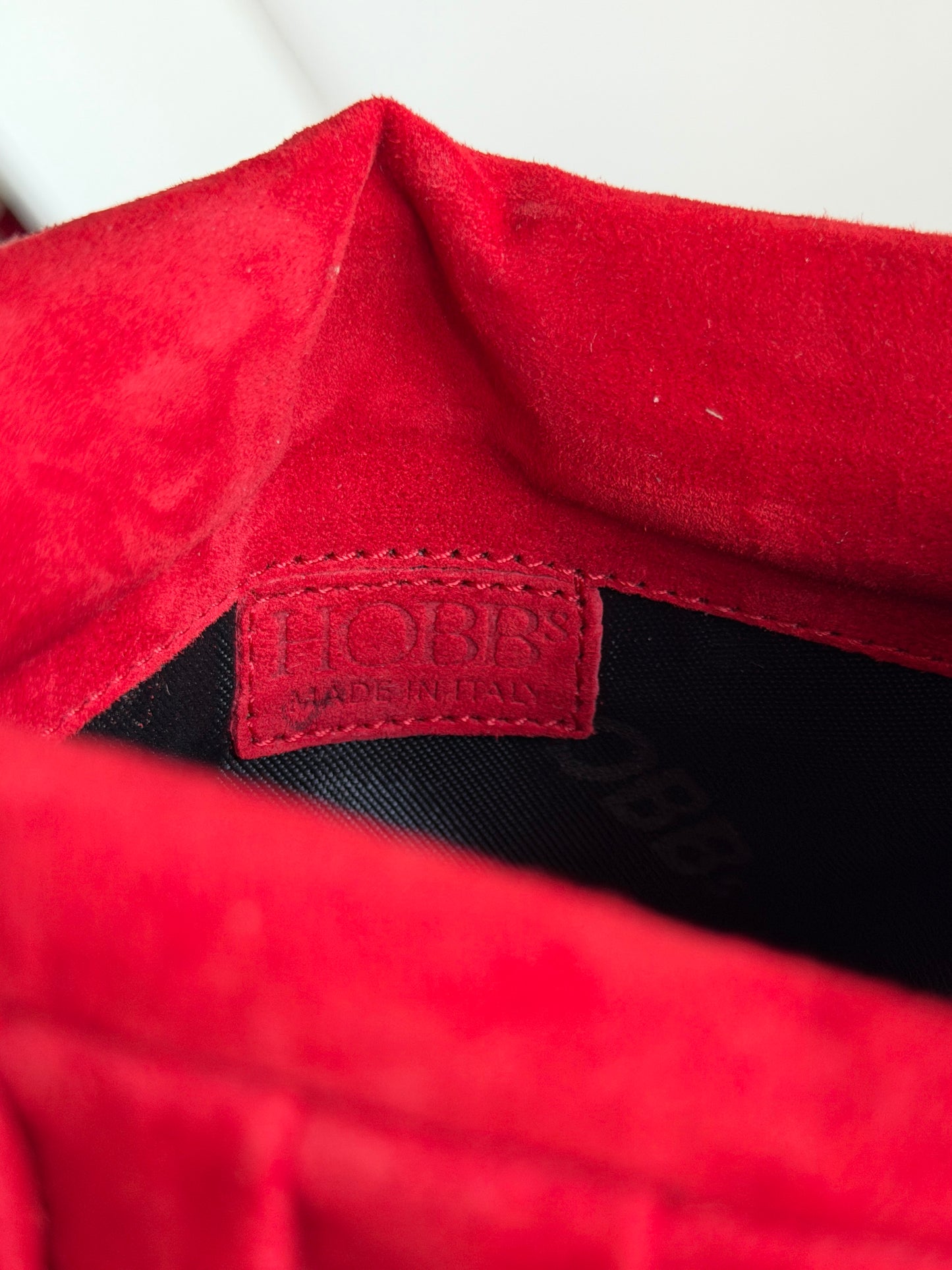 Vibrant red bag crafted from soft suede by Hobbs