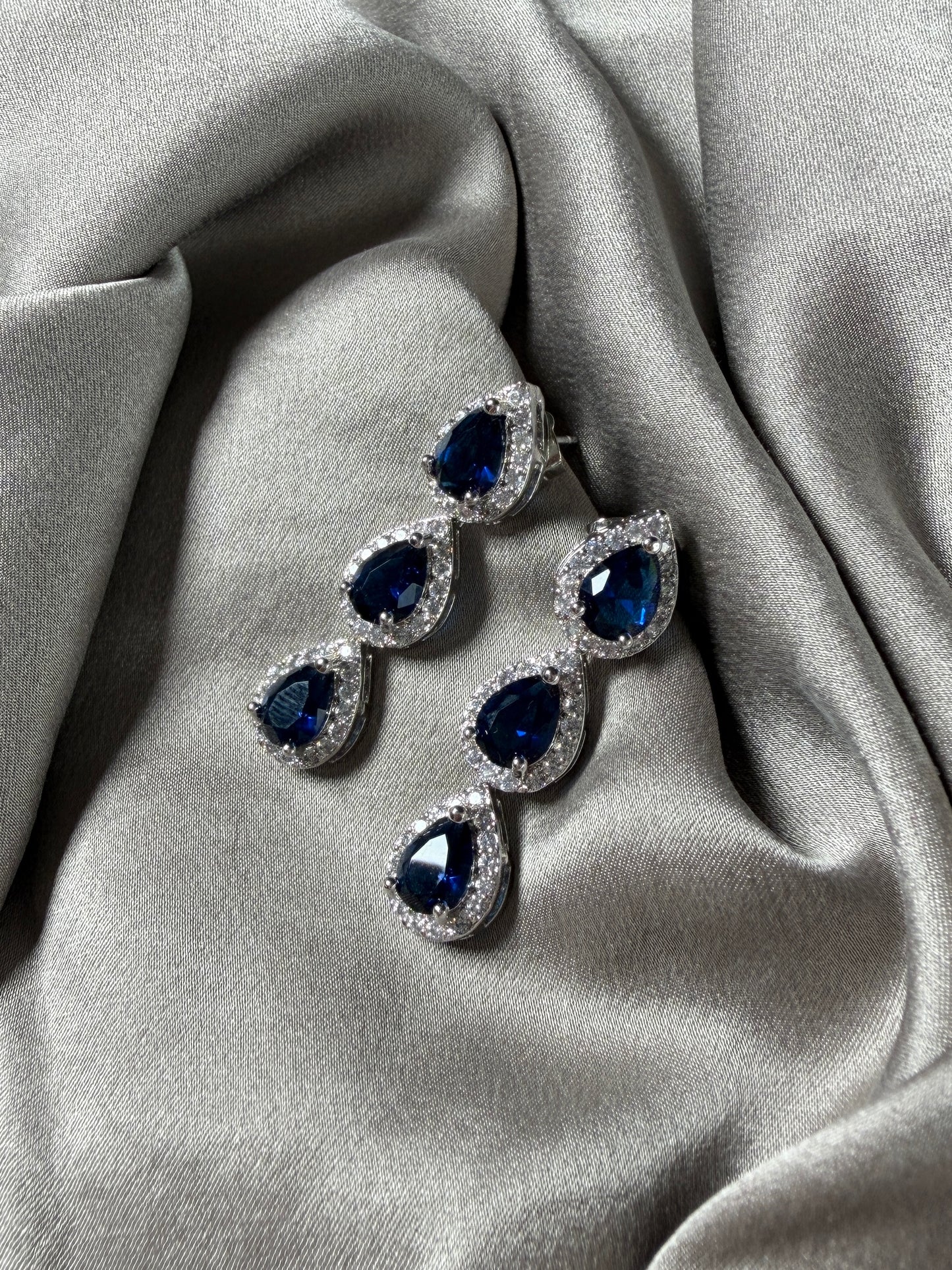 Exquisite earrings featuring a cascade of deep blue stones