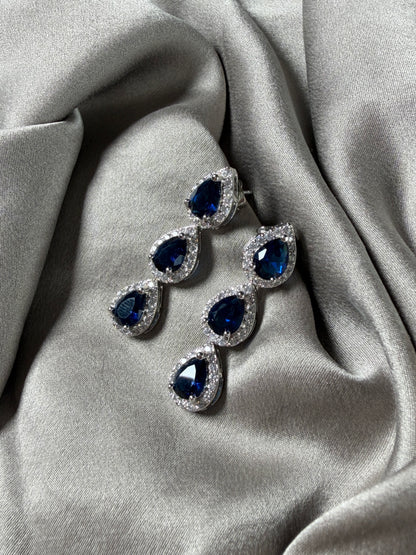 Exquisite earrings featuring a cascade of deep blue stones