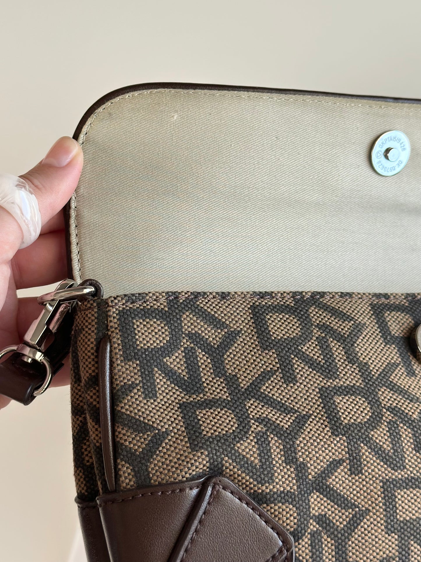 Chic vintage DKNY baguette bag with a rich brown monogram pattern