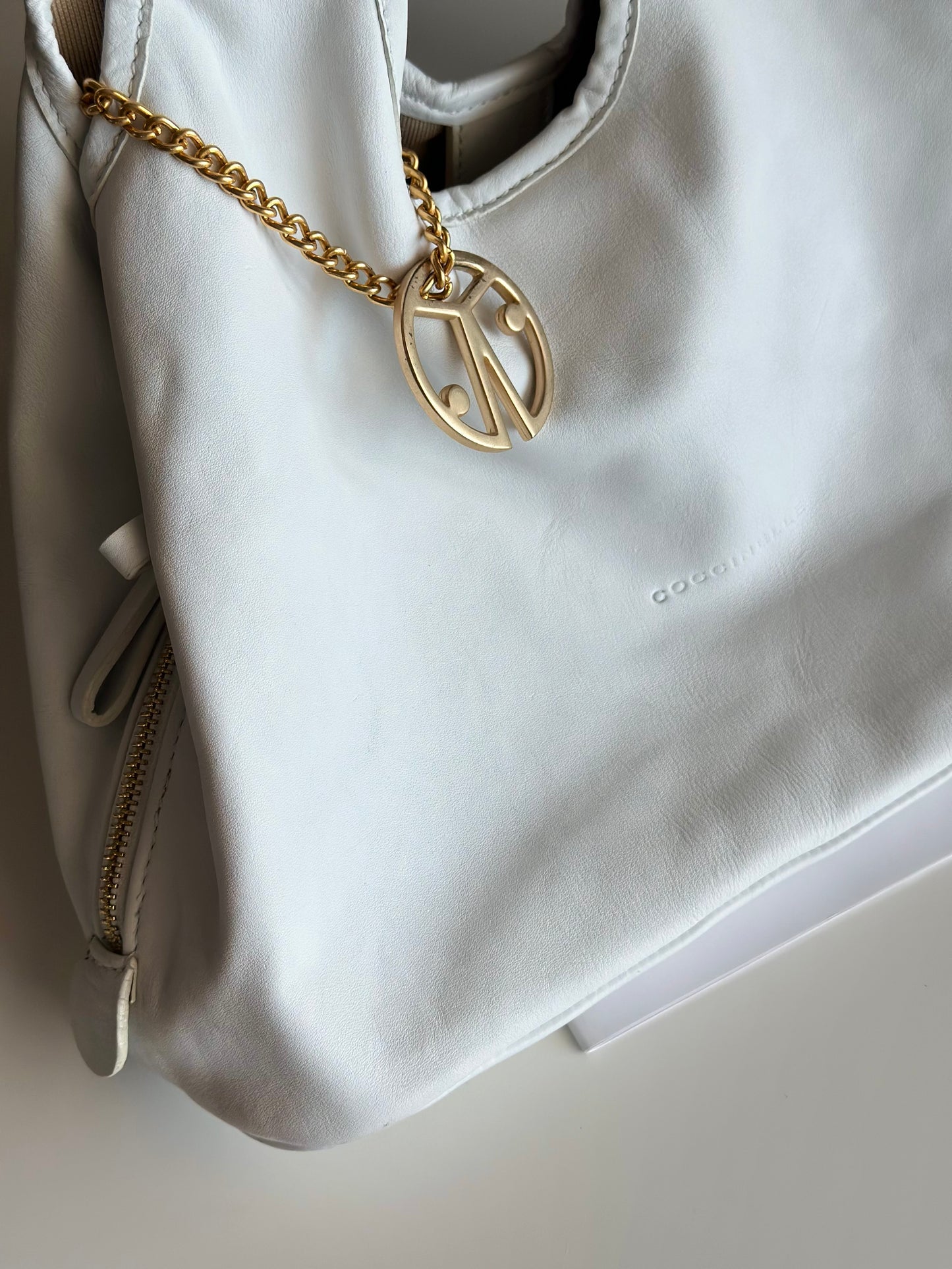 Stylish Coccinelle bag in soft white leather