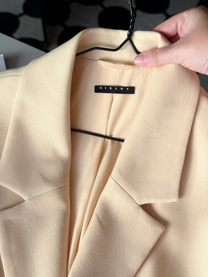 Stylish pale yellow long trench coat